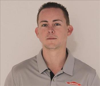 A SERVPRO employee is shown in a gray shirt with SERVPRO logo