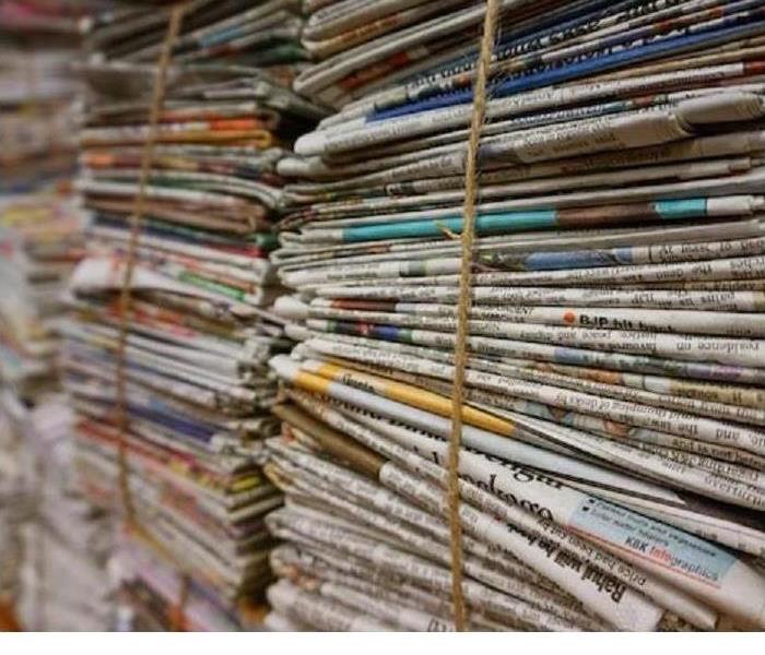 Stacks of old Newspapers are shown 