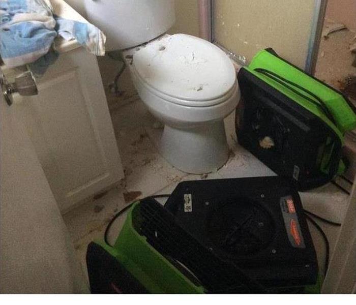SERVPRO drying equipment is shown in a damaged bathroom